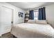 Bedroom with a king-sized bed, blue curtains, and overhead lighting at 4926 Crittenden Ave, Indianapolis, IN 46205