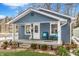 Charming blue house with a welcoming porch and well-manicured lawn at 4926 Crittenden Ave, Indianapolis, IN 46205