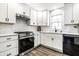 Kitchen featuring stainless steel appliances, white cabinets, and ample counter space at 4926 Crittenden Ave, Indianapolis, IN 46205