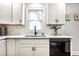 Close up on kitchen with a black sink and faucet plus stainless steel appliances at 4926 Crittenden Ave, Indianapolis, IN 46205