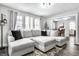 Bright living room featuring a large sectional sofa, hardwood floors, and abundant natural light at 4926 Crittenden Ave, Indianapolis, IN 46205