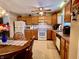 Bright kitchen with oak cabinets, white appliances, and an adjacent dining area at 545 Lake Crossing Ln, Franklin, IN 46131