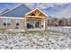 Covered patio with wood beams and a fenced backyard with a light dusting of snow at 5705 W 900 N, McCordsville, IN 46055