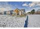 Covered patio with backyard and snow-covered lawn at 5705 W 900 N, McCordsville, IN 46055