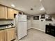 Basement bar area with wet bar and mini fridge at 6351 St Jean Dr, Indianapolis, IN 46217