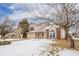 Two-story house with brick and beige exterior, attached garage, and snow-covered front yard at 6573 Crossbridge Dr, Noblesville, IN 46062