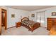 Cozy bedroom with wooden bed frame and dresser at 710 Eagle Pkwy # 15, Brownsburg, IN 46112