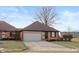 Brick ranch home with attached garage and landscaped yard at 710 Eagle Pkwy # 15, Brownsburg, IN 46112