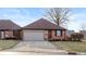 Brick ranch home with attached garage and landscaped yard at 710 Eagle Pkwy # 15, Brownsburg, IN 46112