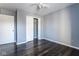 Bright bedroom with dark wood-look floors and ceiling fan at 7328 Woodside Dr, Avon, IN 46123