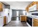 Open kitchen featuring wood cabinets, white appliances, and vinyl flooring at 7328 Woodside Dr, Avon, IN 46123