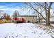 Spacious backyard with a wooden deck and a snow-covered lawn at 7803 Opelika Ct, Indianapolis, IN 46217
