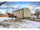 Landscaped backyard with wooden deck and snow covered lawn at 7803 Opelika Ct, Indianapolis, IN 46217