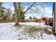 Backyard with a deck, shed, and partially snow-covered lawn at 7803 Opelika Ct, Indianapolis, IN 46217