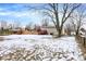 Backyard view of home with a wooden deck and a partially snow-covered lawn at 7803 Opelika Ct, Indianapolis, IN 46217