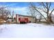 Large backyard with a red deck and a partially snow-covered lawn at 7803 Opelika Ct, Indianapolis, IN 46217