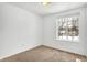 Spacious bedroom with neutral carpeting and large window at 7803 Opelika Ct, Indianapolis, IN 46217