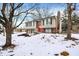 2-story house with red front door, 2-car garage, and snowy yard at 7803 Opelika Ct, Indianapolis, IN 46217