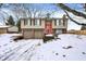 2-story house with red front door, 2-car garage, and snowy yard at 7803 Opelika Ct, Indianapolis, IN 46217