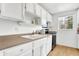 Kitchen boasts white cabinets, new appliances, and a double sink at 7803 Opelika Ct, Indianapolis, IN 46217