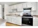 Modern kitchen with white cabinets and stainless steel appliances at 7803 Opelika Ct, Indianapolis, IN 46217