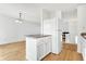 Kitchen with white cabinets, a breakfast bar, and hardwood floors at 7803 Opelika Ct, Indianapolis, IN 46217