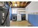 Basement laundry room with washer, dryer, and storage shelves at 7803 Opelika Ct, Indianapolis, IN 46217