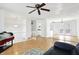 Open living room with hardwood floors, kitchen, and access to deck at 7803 Opelika Ct, Indianapolis, IN 46217