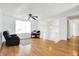 Living room with hardwood floors, recliner, and loft view at 7803 Opelika Ct, Indianapolis, IN 46217