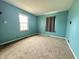 Bedroom features neutral carpet, a large window providing natural light, and a ceiling light fixture at 7903 Roseway Ct, Indianapolis, IN 46226