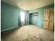 Bright bedroom with neutral carpet, window providing natural light, and a built-in closet for storage at 7903 Roseway Ct, Indianapolis, IN 46226