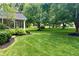 Large backyard with lush green grass and mature trees at 820 Dayton Dr, Carmel, IN 46033