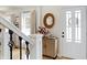 Bright entryway with staircase, wood cabinet, and mirror at 820 Dayton Dr, Carmel, IN 46033