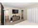 Bedroom with ensuite bathroom, dresser, and large TV at 8224 Barry Rd, Indianapolis, IN 46219