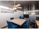 Dining area with a marble table, blue chairs, and a city-themed curtain at 8224 Barry Rd, Indianapolis, IN 46219