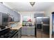 Gray kitchen with stainless steel appliances and ample counter space at 8224 Barry Rd, Indianapolis, IN 46219