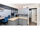 L-shaped kitchen with gray cabinets and a corner sink at 8224 Barry Rd, Indianapolis, IN 46219
