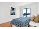 Serene bedroom with a queen-size bed and large window with a view at 855 N East St # 302, Indianapolis, IN 46202