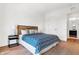 Spacious bedroom with queen bed, light wood floors, and access to a bathroom at 855 N East St # 302, Indianapolis, IN 46202