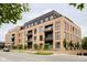 Modern brick building with multiple balconies and ground floor retail at 855 N East St # 302, Indianapolis, IN 46202