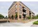 Brick building with parking garage and landscaped grounds at 855 N East St # 302, Indianapolis, IN 46202