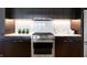 Stainless steel appliances and dark wood cabinets in modern kitchen at 855 N East St # 302, Indianapolis, IN 46202