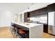 Modern kitchen with dark cabinetry, marble island, and stainless steel appliances at 855 N East St # 302, Indianapolis, IN 46202