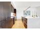 Modern kitchen with dark cabinetry, marble island, and stainless steel appliances at 855 N East St # 302, Indianapolis, IN 46202