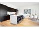 Modern kitchen with dark cabinetry, marble island, and stainless steel appliances at 855 N East St # 302, Indianapolis, IN 46202