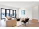 Living room with balcony access, hardwood floors, and neutral decor at 855 N East St # 302, Indianapolis, IN 46202