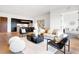 Open living room showcasing hardwood floors, modern furniture, and an adjacent kitchen at 855 N East St # 302, Indianapolis, IN 46202