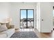 Light-filled living room features a comfortable sofa and large window with city views at 855 N East St # 302, Indianapolis, IN 46202