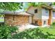 View of the house's backyard with a brick exterior and a door leading outside, surrounded by grass at 9157 Neptune Dr, Indianapolis, IN 46229