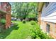 Yard featuring brick details, with sheds, a covered porch and a lawn at 9157 Neptune Dr, Indianapolis, IN 46229